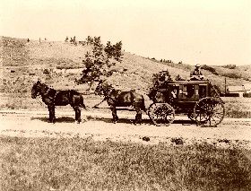 Stagecoach with guard sitting on top, protecting whatever wealth it might  have been carrying.