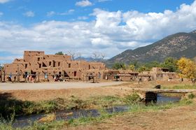 Taos Pueblo and river, New Mexico by Kathy Alexander.